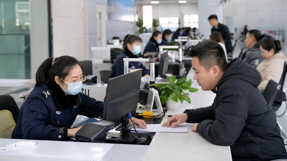工作人员在窗口核验办理材料